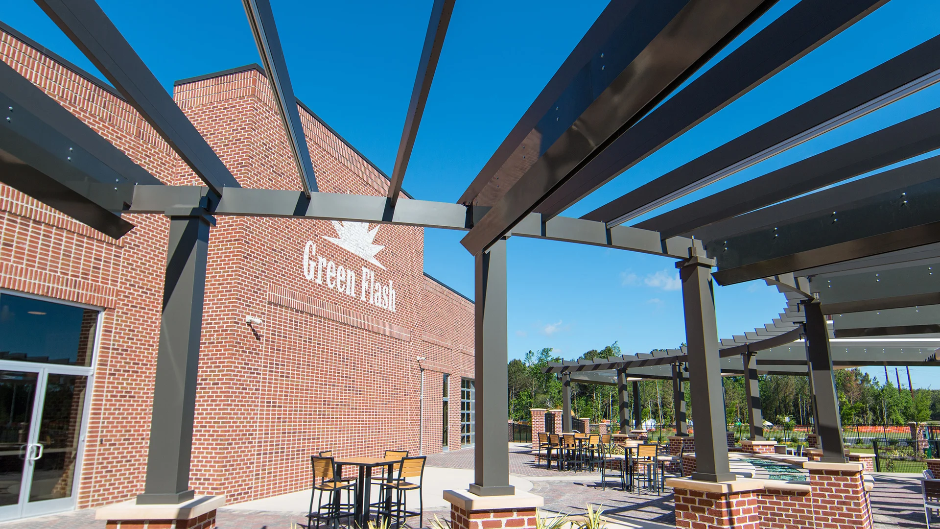 Featured image for “Green Flash Brewery – Radius Trex Pergola with Retractable Canopies”Green Flash Brewing has transformed their large outdoor patio into a spectacular beer haven! This beautiful, fully functional, custom Trex Pergola frames the beer garden’s curves with a12484:full