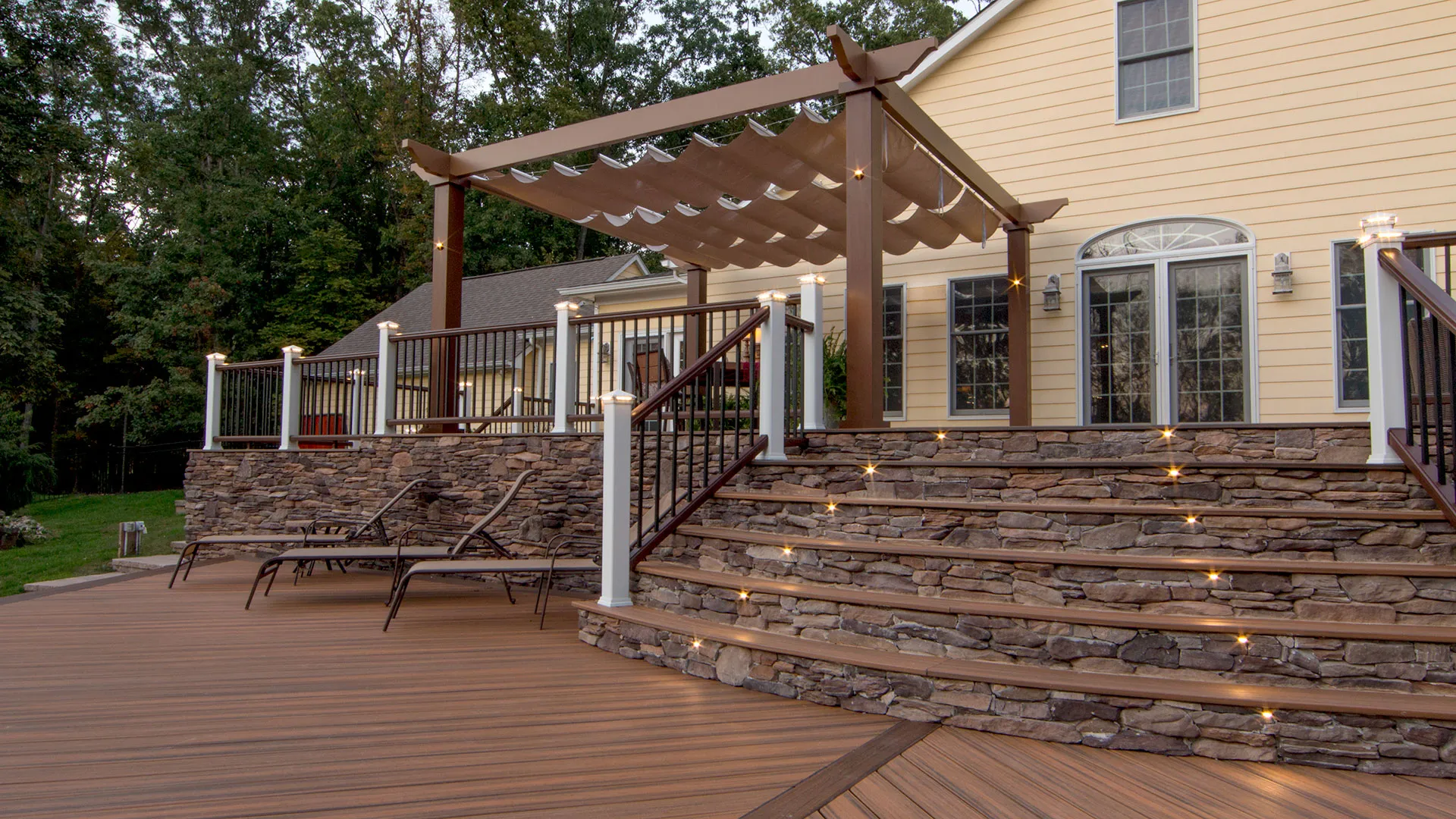 Trex Pergola Vision with retractable canopy on backyard deck, this is one of a dozen pergola kits available from Trex