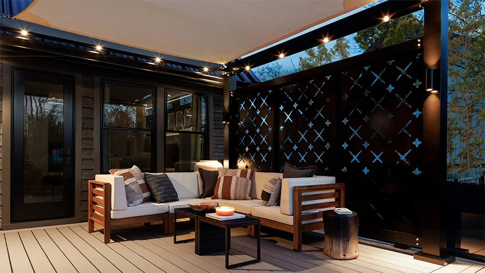 Trex Solis pergola with attached privacy screen and lights providing privacy and shade to an outdoor space.